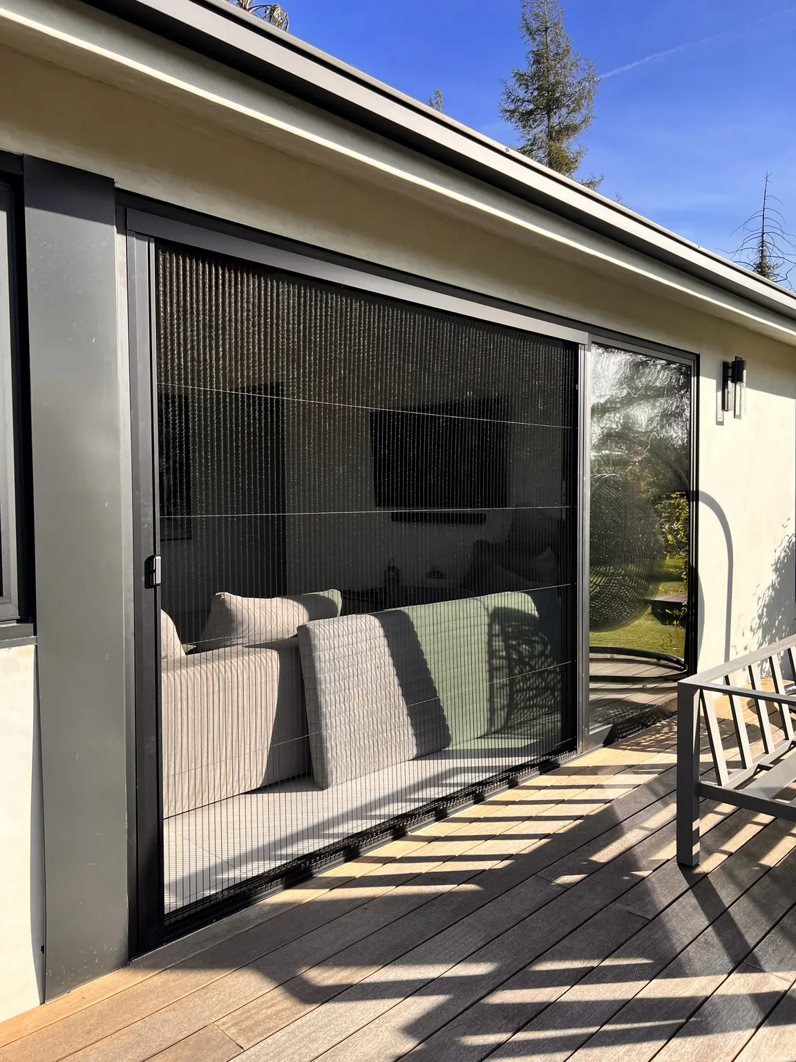Aire pleated screen deployed across a slider, seen from the deck