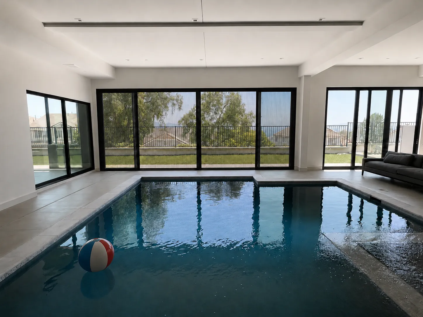 A full wall of Aire pleated screens over an indoor pool