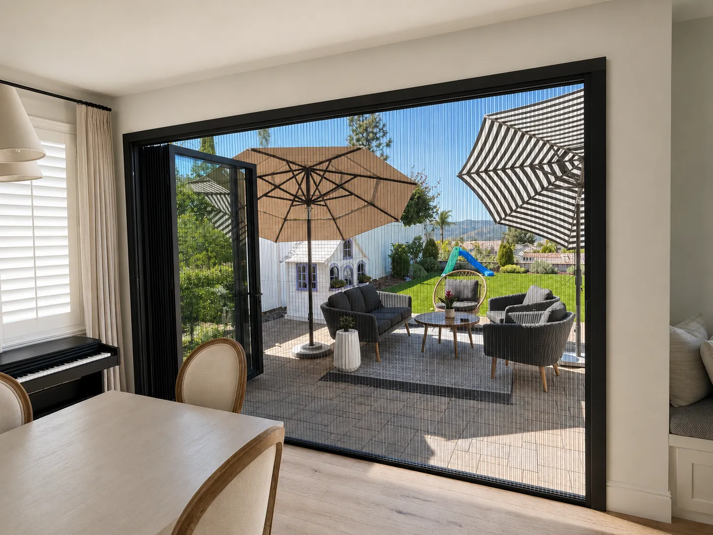 Aire pleated screen drawn across a wide slider to a backyard patio
